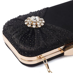crystal jewelled clutch bag with pleated satin bow in Black